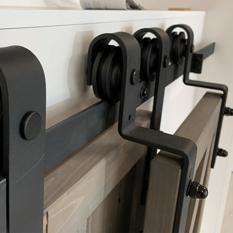 Wall mounted rollers for bypassing doors